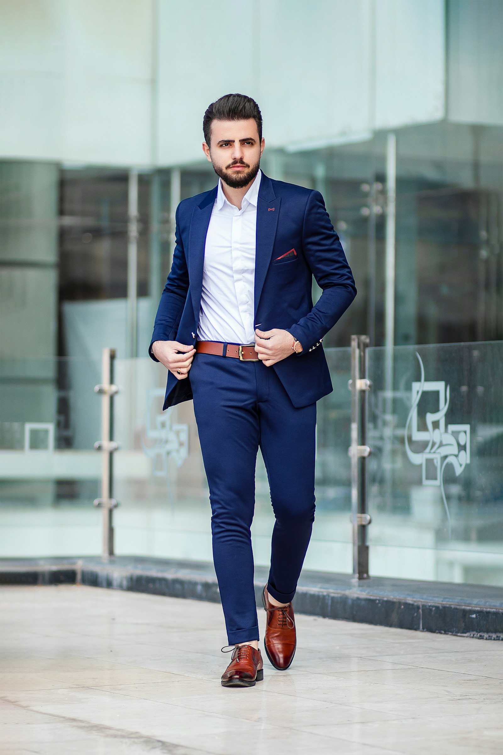 Tailored navy outfit shown from jacket through shoes.