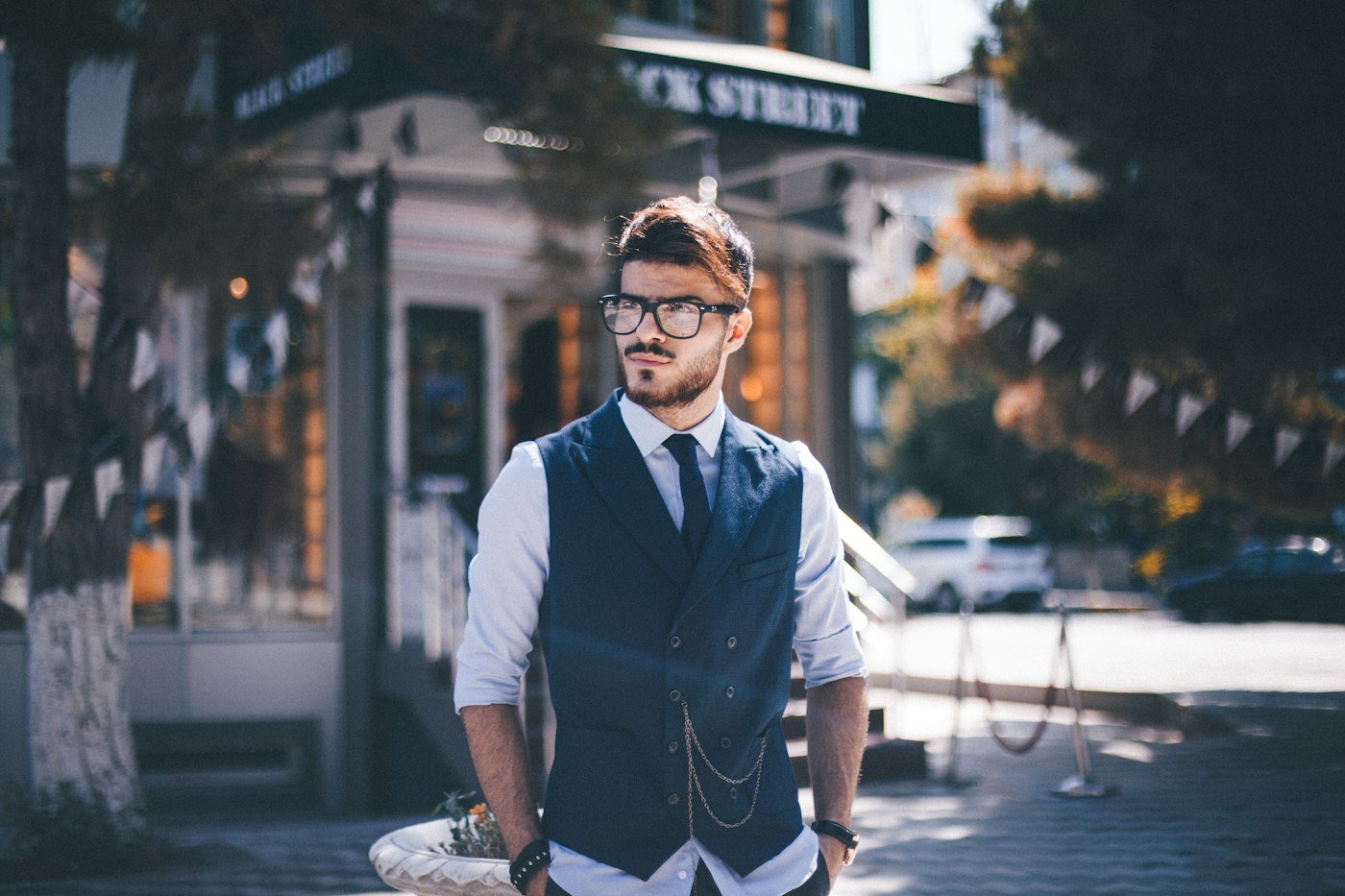 Navy vest styled with a shirt and tie.